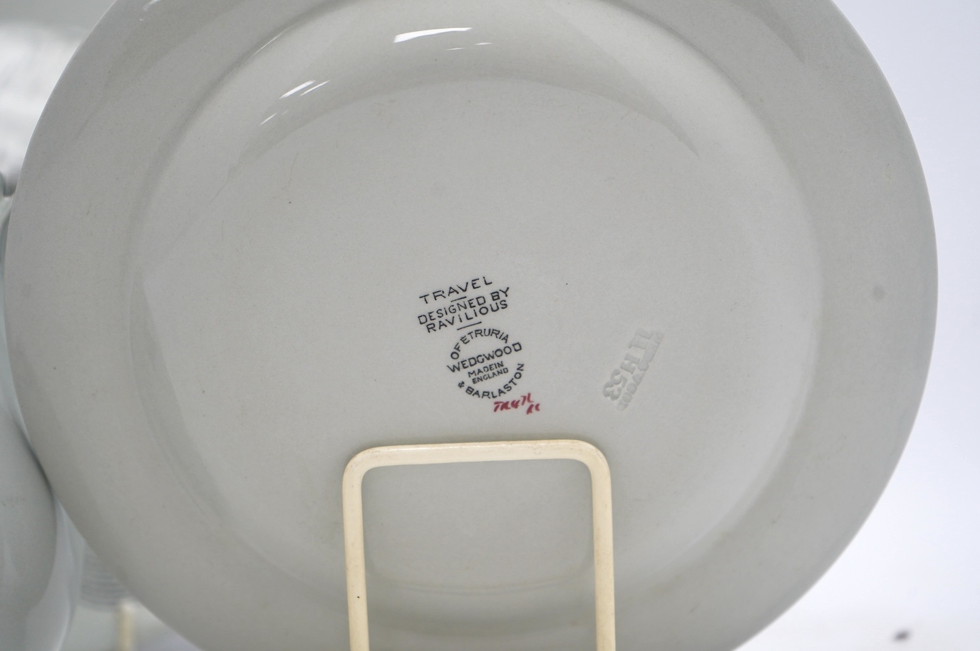Four Wedgwood pottery items; all Travel pattern designed by Ravilious, comprising a small jug, 11.5cm high, and three plates. Condition - fair to good, minor marks and one chip to the jug only